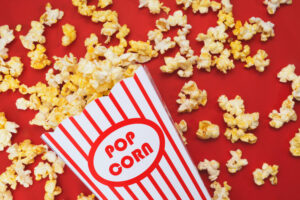 Stock image of popcorn on a red background